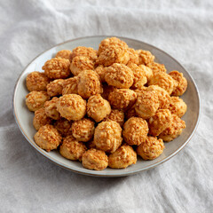 Homemade Crumbly Biscuits with Parmigiano Reggiano on a Plate, side view. Close-up.
