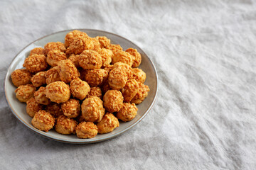 Homemade Crumbly Biscuits with Parmigiano Reggiano on a Plate, side view. Space for text.