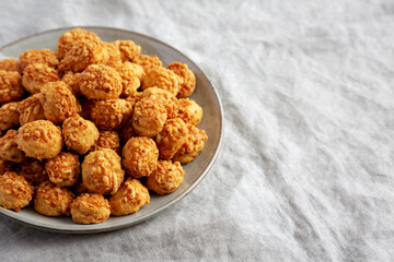 Homemade Crumbly Biscuits with Parmigiano Reggiano on a Plate, side view. Copy space.