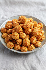Homemade Crumbly Biscuits with Parmigiano Reggiano on a Plate, side view.