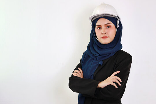 Bueautiful engineer young asian woman wearing blue muslim suit smiling confident in studio. Isolated white background portrait with beautiful face girl with blue hijab. Advertisement portrait concept.