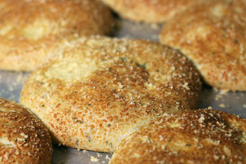 Breads on tray with cheese topping. Close-up on baking sheet in the oven.