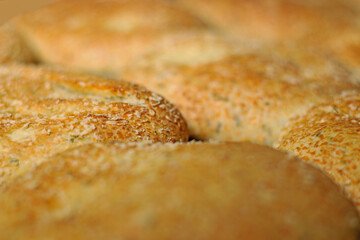Breads on tray with cheese topping. Close-up on baking sheet in the oven.