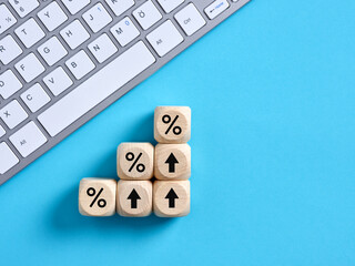 Percent or percentage symbols on wooden cubes. Calculating increasing financial interest rates or...