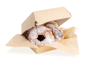 Fresh delicious homemade doughnuts sprinkled with powdered sugar on kraft napkins in a slightly...