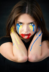  Ukrainian woman with a bloody tears. Young woman is feeling emotional pain after reading the news. Freedom and patriot of Ukraine.Pray for Ukraine. Stop war. Blue yellow 