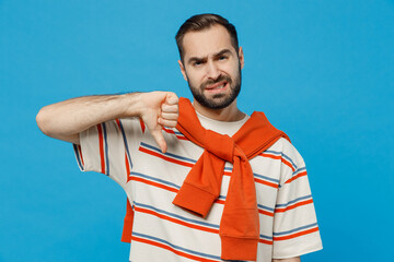 Young sad displeased dissatisfied caucasian man 20s in orange striped t-shirt look camera show...