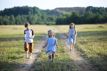 Children walk in the summer in nature. Child on a sunny spring morning in the park. Traveling with children.