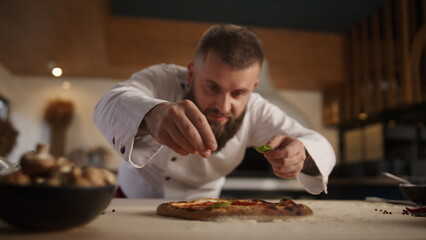 Chef making vegetarian pizza in restaurant kitchen. Italian food tasty concept.