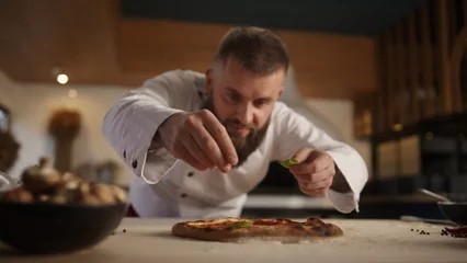 Outdoor-Kissen Chef making vegetarian pizza in restaurant kitchen. Italian food tasty concept. © stockbusters