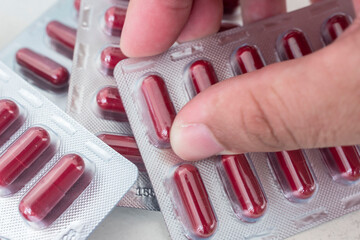 Holding a blister pack of Clindamycin Hydrochloride capsules. 300 mg antibacterial treatment....