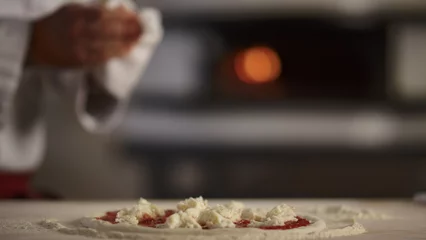  Pastry cook making pizza pepperoni in restaurant kitchen. Cooking food concept. © stockbusters