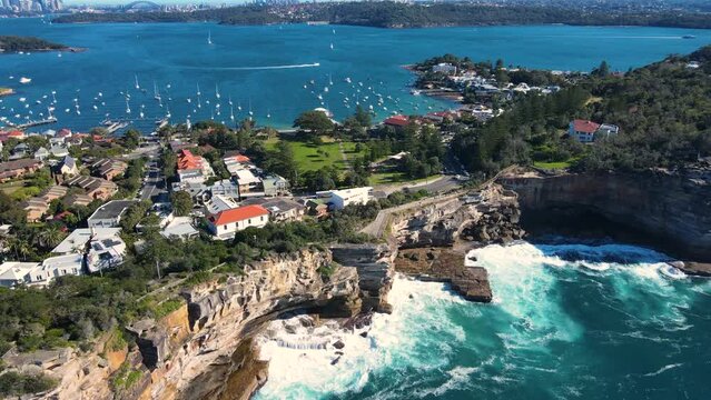 Aerial drone view of Watsons Bay in East Sydney, Australia along the coastal clifftop and walkway at The Gap famous lookout on a sunny day