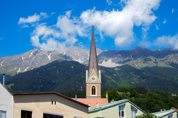 Fototapeta na wymiar Gothic cathedral tower in Innsbruck Old town in Alps mountains, Tyrol, Austria