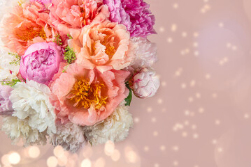 Abundance of Fresh bunch of Peonies Bouquet of different pink colors on light pink background. Card Concept, copy space for text