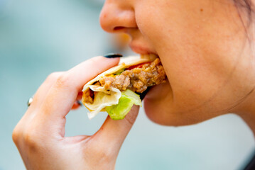 woman eat taco outdoor traditional in mexican food. street food