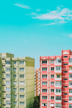 Green and orange panel building architecture houses. Nine-story old urban residential houses with windows