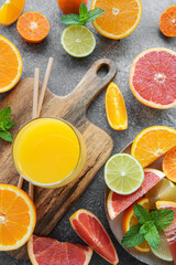 Glasses of juice and citrus fruits