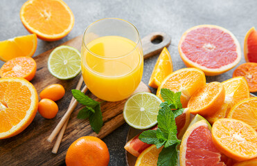 Glass of juice and citrus fruits