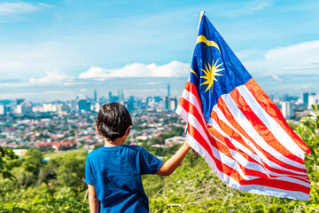 The children are holding malaysia flag. All over Malaysia will be flagged for the celebration of...