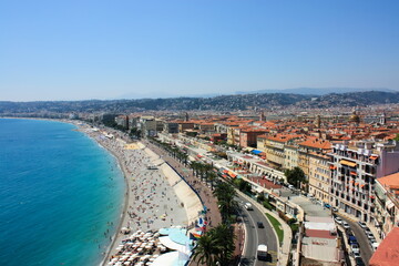 Photo of the Promenade de Anglais taken in Nice, France on a sunny summer day. Image was taken on the way to Colline du Château (Castle Hill). - obrazy, fototapety, plakaty