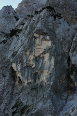 Rock cliff with human face. Ajdovska Deklica on Prisojnik/Prisank mountain in the Julian Alps, Slovenia.