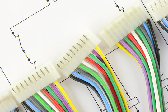 Colored copper wires on an electrical diagram in close-up.	