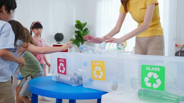 Asian beautiful young woman teacher teaching mixed race kids at school.