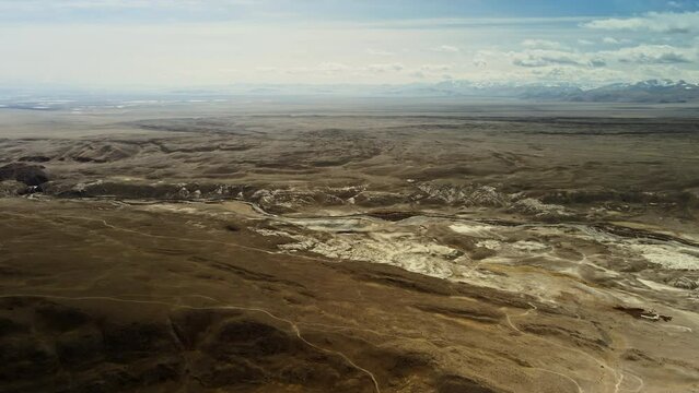 Mountain valley in spring. Aerial photography at high altitude. Blue sky with gray clouds.