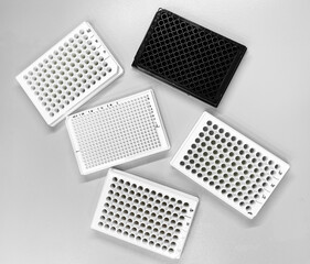 Different types of multiwell plates on the laboratory bench. Such plates are used for biological in...