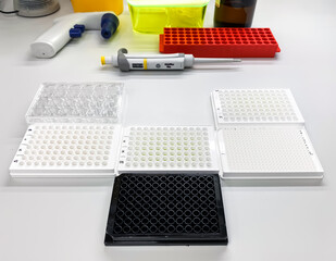 Different types of multiwell plates on the laboratory bench. Such plates are used for biological in...