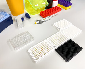 Different types of multiwell plates on the laboratory bench. Such plates are used for biological in...