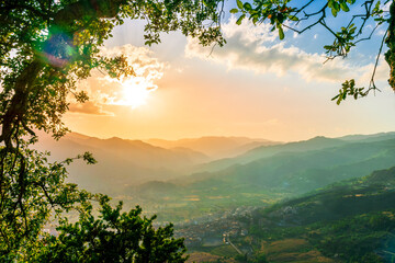 picturesque highland landscape with amazing view from mountain with green branches and leaves on sides