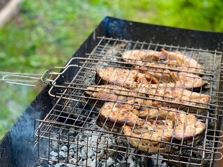 Fish on the grill in clouds of smoke 