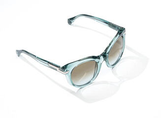 Fashion sunglasses in sunlight on summer yellow background. Woman stylish eyeglasses for banner.