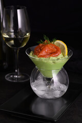 Taste is a combination of avocado pulp with a delicate texture of soft  cheese cream and salmon, with the addition of dill and a slice of lemon. Serving verrine in a Martini Chiller with ice. Aperitif