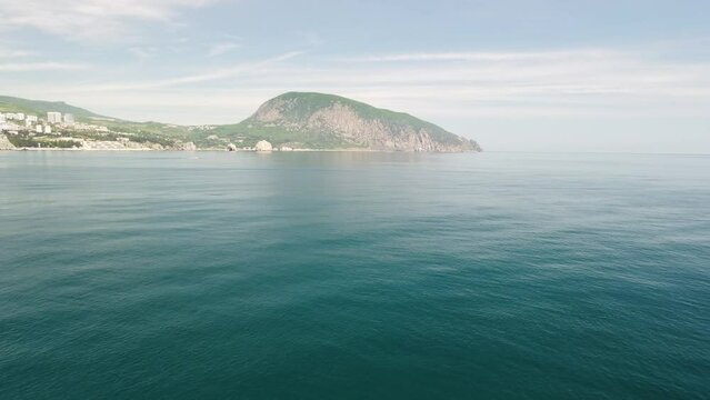 Gurzuf resort city panoramic view on Bear Mountain, Ayu-Dag, Yalta, Crimea. Spring sunny day. Nature summer ocean sea beach background. Vacation, travel and holiday concept.