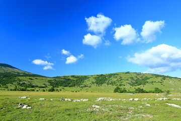 Mountain landscape with meadows and hills. Karst field in Lika region, Croatia.