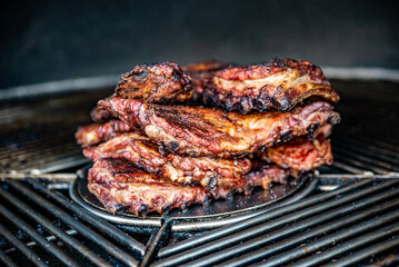 Stack of grilled pork ribs in grill