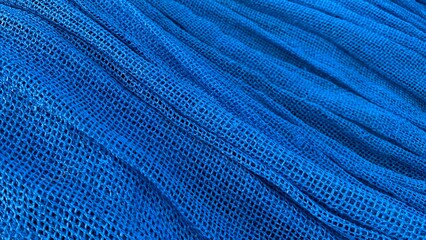 Background and texture of wavy windbreak netting with blue color
