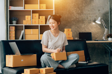Asian woman working in modern warehouse and delivery service via modern technology