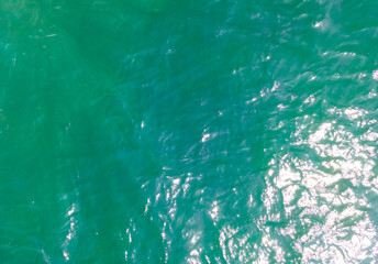 Aerial Drone photo. Beautiful turquoise green water background on summer sea beach. Relax and travel concept. Warm sunny weather.