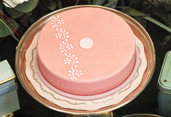 refined pink strawberry cake decorated with white sugar designs