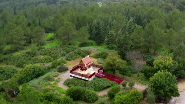 Aerial Panning Shot Of Famous Buddhist Temple In National Forest, Drone Flying Over Green Trees - Ben Shemen Forest, Israel