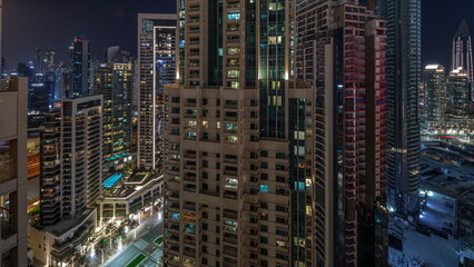 Fototapeta na wymiar Aerial cityscape night timelapse with illuminated architecture of Dubai downtown.