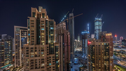 Fototapeta premium Aerial cityscape night timelapse with illuminated architecture of Dubai downtown.
