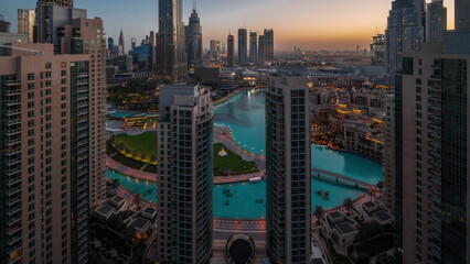 Dubai Downtown cityscape with tallest skyscrapers around aerial night to day timelapse.
