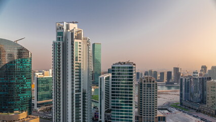 Fototapeta na wymiar Business Bay Dubai skyscrapers with water canal aerial timelapse.