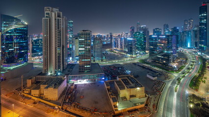 Fototapeta na wymiar Business Bay Dubai skyscrapers with water canal aerial night timelapse.