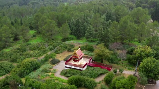 Aerial Panning Shot Of The Thai Pagoda In Green Forest - Ben Shemen Forest, Israel